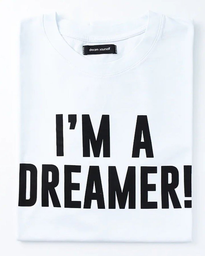 Folded white T-shirt printed with the words “I’M A DREAMER!”