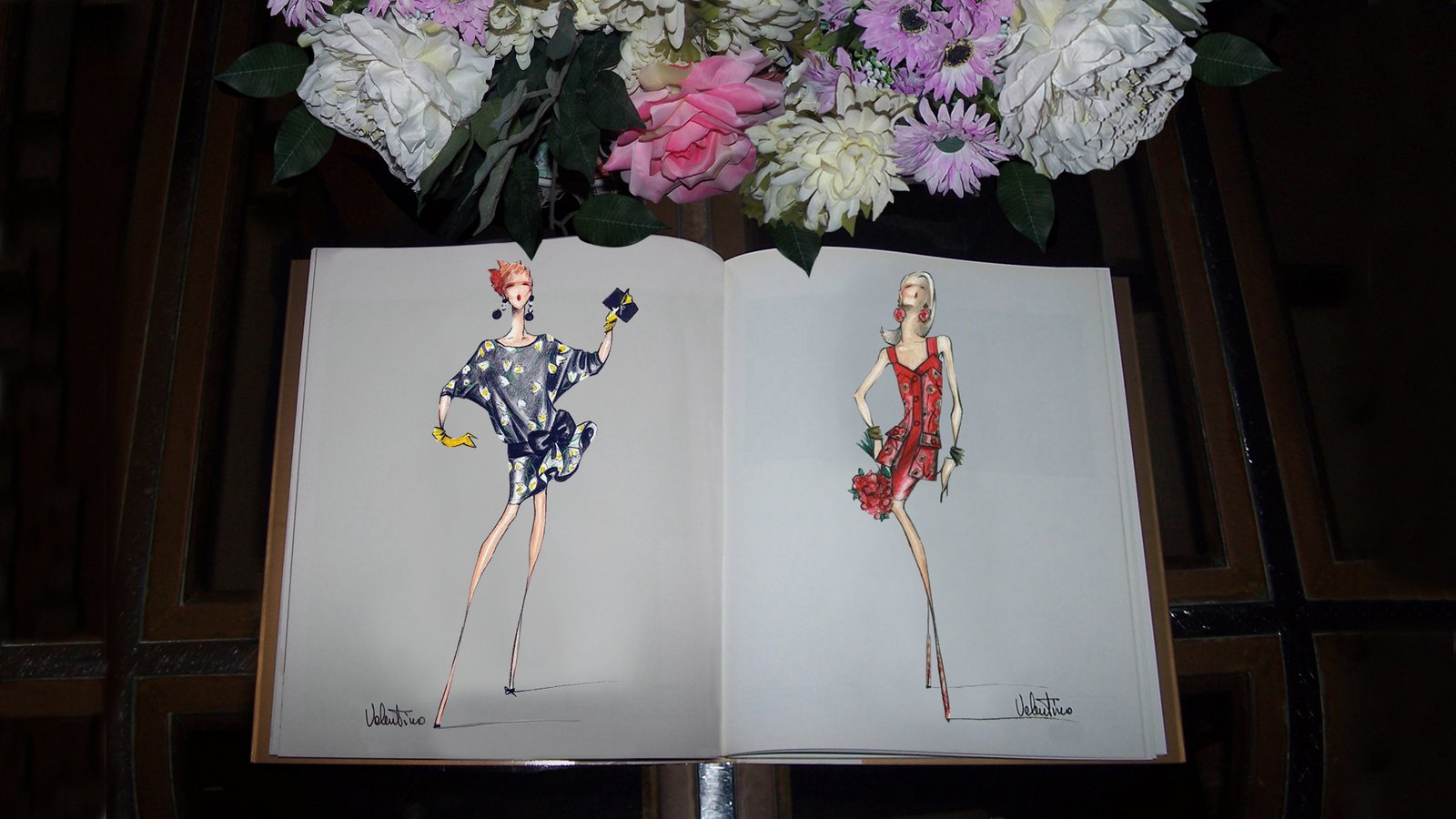 A book open at two Valentino fashion illustrations, photographed on Fabio Menconi’s table.