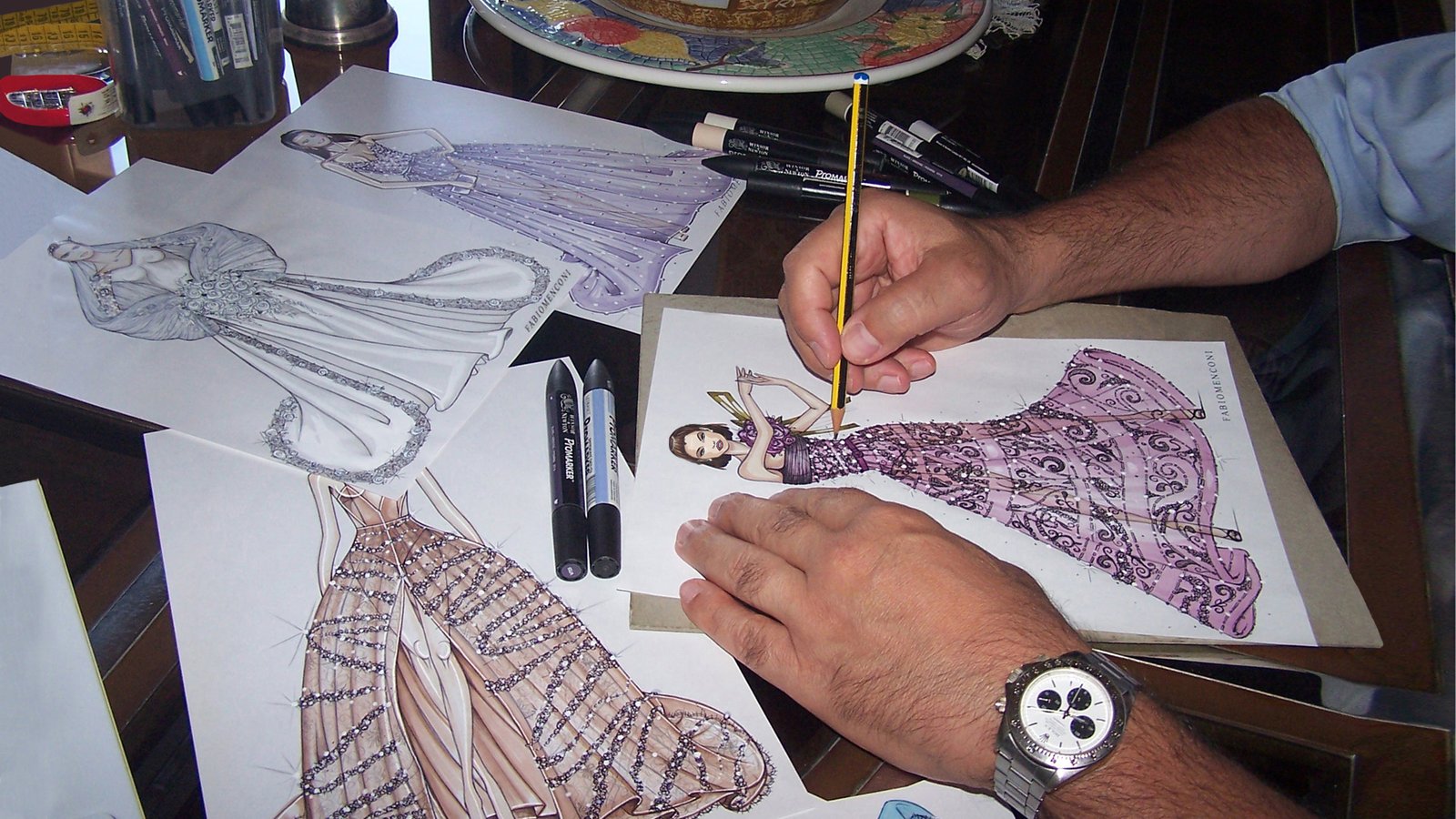 Fabio Menconi colouring an illustration of a purple gown.