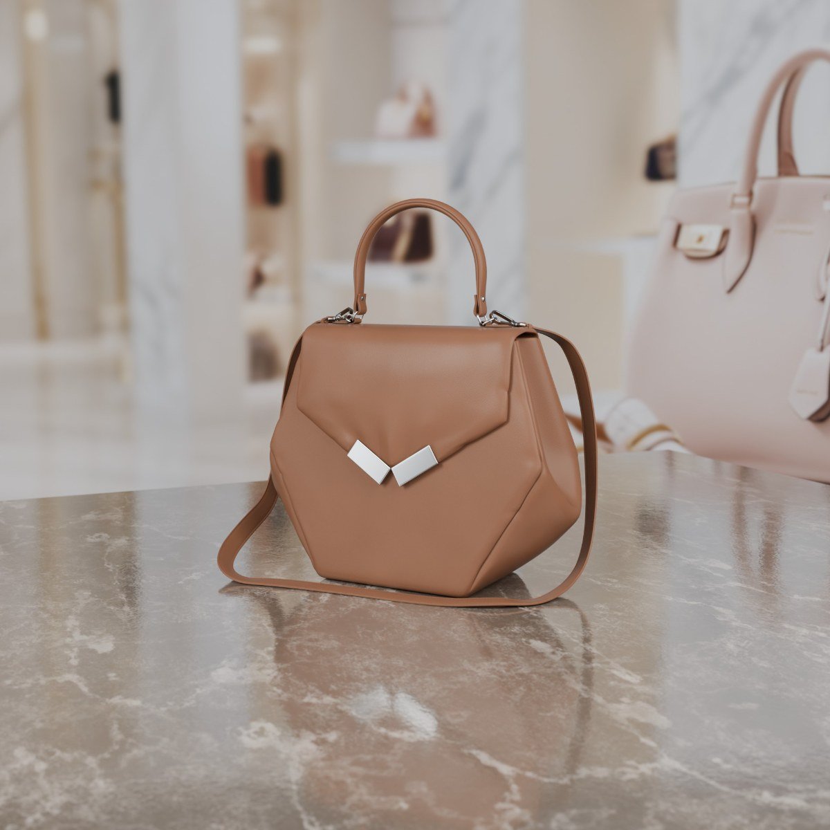A nude leather bag with a hexagonal shape, a top handle and a shoulder strap.